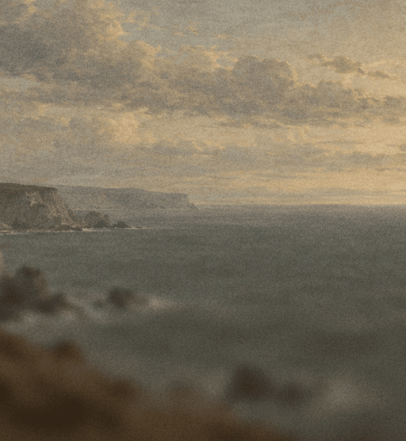 Coastal cliffs under a cloud-filled sky